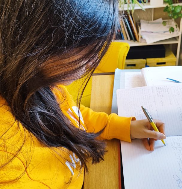 Жена, която пише целите си – символ на силата на повторението и новото начало